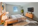 Modern staged bedroom with natural wood accents, TV, and plush rug at 2725 St Augustine Trl, Marietta, GA 30067
