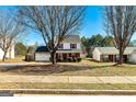 Charming two-story home with a well-maintained front yard, brick accents, and a two-car garage at 261 Whistle Way, Locust Grove, GA 30248