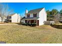 Charming two-story home with a well-maintained front yard, brick accents, and a two-car garage at 261 Whistle Way, Locust Grove, GA 30248