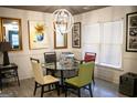 Bright dining area featuring a modern light fixture, glass table, and unique art on the walls at 1899 Se Cooper Landing Se Dr, Smyrna, GA 30080