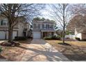 Charming two-story home with gray siding, black shutters, covered porch, and a well-manicured front yard at 5790 Ridge Stone Way, Cumming, GA 30041