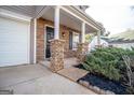 Inviting front porch with stone pillars, offering a cozy outdoor space at 5790 Ridge Stone Way, Cumming, GA 30041