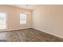 Open dining room featuring wood-look floors and a contemporary chandelier at 116 Jacoby Dr # 112, Fairburn, GA 30213