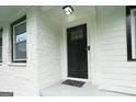 Close-up of a freshly painted front door, framed by brick and modern windows at 2508 Sylvan Rd, East Point, GA 30344