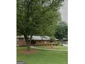 Beautiful brick home with mature trees, well-maintained landscaping, and a circular driveway at 650 Foxcroft Se Cir, Marietta, GA 30067
