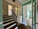 Upstairs hallway with hardwood flooring, stairs, and a nearby bedroom at 650 Foxcroft Se Cir, Marietta, GA 30067