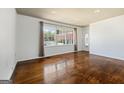 Bright living room featuring hardwood floors, a large window, and white walls at 623 Swan Lake Rd, Stockbridge, GA 30281