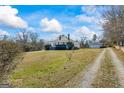 Spacious property featuring a charming home, lush lawn, and detached garage at 1669 Spring Ne St, Conyers, GA 30012