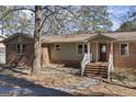 Inviting front porch with brick and siding, a small porch and stairway leading to the front door at 2545 Rockbridge Nw Rd, Conyers, GA 30012