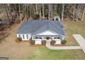 Aerial view of a single-story home with a well-maintained yard, set on a treed lot at 505 Phillips Dr, Palmetto, GA 30268