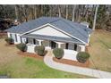 Angled view showcasing well-manicured lawn and inviting front porch of this cozy home at 505 Phillips Dr, Palmetto, GA 30268