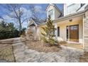 This home features a covered porch, a stone accent wall, and a neatly landscaped yard with mature trees at 603 Honey Creek Rd, Mcdonough, GA 30252