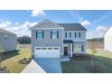 Inviting two-story home with attached garage, manicured lawn, and neutral gray color scheme at 552 Whitman Lane # 2014, Stockbridge, GA 30281