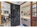 Open front door leading to a dining area and showing a view of the front porch at 108 Everhill, Peachtree City, GA 30269