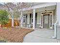 Charming front porch with outdoor seating and attractive landscaping surrounding the entrance at 722 Gittings Ave, Peachtree City, GA 30269