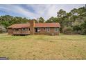 Expansive backyard featuring a wooden deck, perfect for outdoor entertaining at 5687 Highway 212 N, Covington, GA 30016