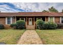 Inviting front entrance with wooden porch, leading to a charming home exterior at 5687 Highway 212 N, Covington, GA 30016