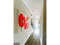 Bright hallway showcasing hardwood floors leading up to a staircase at 11118 Benton Dr # F5, Covington, GA 30014