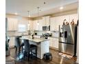 Modern kitchen with stainless steel appliances, granite countertops, and white cabinetry at 11118 Benton Dr # F5, Covington, GA 30014