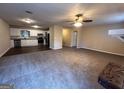 Spacious open-concept living room and kitchen area featuring modern appliances and ceiling fan at 3756 Bright Star Rd, Douglasville, GA 30135