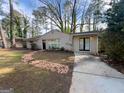 Ranch style home with a brick walkway, and small garden at 3401 Longleaf Dr, Decatur, GA 30032