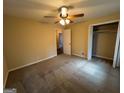 Spacious bedroom with a ceiling fan, plush carpeting, and a large closet at 128 Sewanee Nw Ave, Atlanta, GA 30314