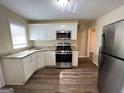 Modern kitchen with stainless steel appliances, granite countertops, and white cabinetry at 128 Sewanee Nw Ave, Atlanta, GA 30314
