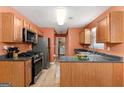 Efficient kitchen featuring stainless steel appliances, wood cabinets and sleek countertops at 704 Davenport Ct, Stockbridge, GA 30281