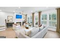 Bright and airy living room with a fireplace, hardwood floors, and lots of natural light at 5769 Tillman Way, Powder Springs, GA 30127