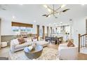 Spacious living room open to kitchen with hardwood floors, modern light fixture, and neutral decor at 5769 Tillman Way, Powder Springs, GA 30127