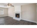 Inviting living room featuring a cozy fireplace, hardwood floors, and bright natural light at 3822 Holland Dr, Snellville, GA 30039