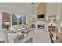 Inviting living room with a fireplace, large windows, and comfortable seating at 6275 Glen Oaks Ln, Atlanta, GA 30328