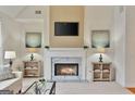 Bright living room featuring a cozy fireplace and neutral color scheme at 6275 Glen Oaks Ln, Atlanta, GA 30328