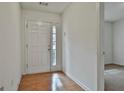 Inviting entryway with hardwood floors, white door with glass panel, and adjacent room view at 4607 Ravenwood Loop, Union City, GA 30291