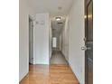 Bright hallway with hardwood floors, neutral walls, and multiple doors leading to various rooms at 4607 Ravenwood Loop, Union City, GA 30291