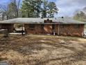 View of the brick home exterior, including a spacious backyard and connecting roof at 5535 Beaver Sw Dr, Mableton, GA 30126