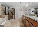 Bathroom with dual sink granite vanity, soaking tub, and glass enclosed tiled shower at 160 Allie Dr, Mcdonough, GA 30252