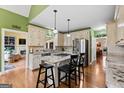 Bright eat-in kitchen features granite countertops, stainless steel appliances, and hardwood floors at 160 Allie Dr, Mcdonough, GA 30252