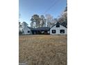 View of the exterior of the property showing a large yard and some trees at 540 Dalrymple Rd, Sandy Springs, GA 30328