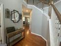 Inviting foyer with hardwood floors, staircase and stylish decorative accents at 4043 Windgrove Xing, Suwanee, GA 30024