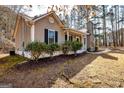 Charming single story home with low-maintenance landscaping, attractive siding and a stone chimney feature at 15 Beaver Creek Run, Sharpsburg, GA 30277