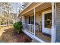 Cozy front porch with white railings and a 'Welcome Spring' sign adding charm to the home's exterior at 15 Beaver Creek Run, Sharpsburg, GA 30277