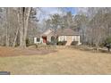 A well-maintained home on a lush lawn, featuring mixed stone and siding accents at 40 High St, Sharpsburg, GA 30277