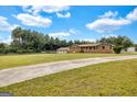 Long driveway leading to a brick home with a spacious front yard and lush surrounding trees at 229 Callaway Rd, Fayetteville, GA 30215