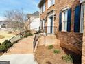 Close-up of the brick steps leading to the front door, featuring black iron railings and tidy landscaping at 5074 Oak Leaf Ter, Stone Mountain, GA 30087