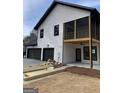 Beautiful modern farmhouse boasting a three-car garage and screened deck perfect for outdoor living at 3785 Pilgrim Mill Rd, Cumming, GA 30041