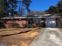 Charming brick home with well-maintained yard, featuring a one-car garage and concrete driveway at 103 Emory Way, Oxford, GA 30054