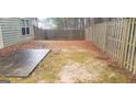 Fenced backyard with small patio perfect for outdoor entertaining and relaxation at 7522 Springbox Dr, Fairburn, GA 30213
