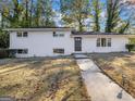White brick house with a well-manicured lawn and walkway leading to the front door at 3044 Sunset Ln, East Point, GA 30344