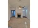 Inviting living room with a stone fireplace, neutral carpet, and a ceiling fan at 181 Linton Dr, Acworth, GA 30102